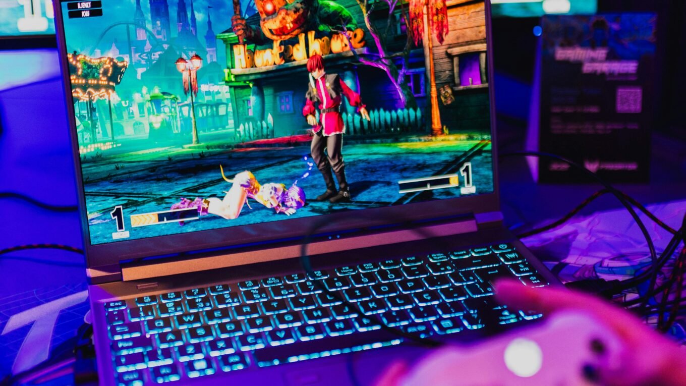 Colorful gaming scene on a laptop with controller, perfect for entertainment visuals.