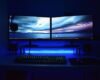 Dual monitors with blue lighting on a gaming desk setup.
